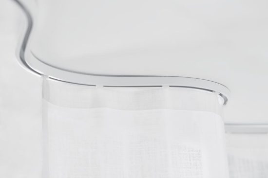 Clear curved curtain track with sheer curtain